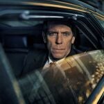 This image released by PBS shows Hugh Laurie as a heedless British politician beset by scandal in the four-episode series "Roadkill," premiering on MASTERPIECE, Sunday, Nov. 1, 2020 on PBS. (MASTERPIECE/PBS via AP)
