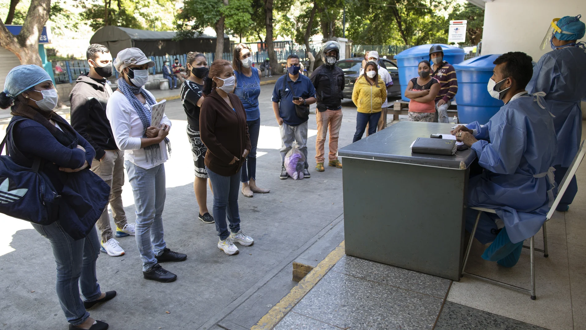 Dr. Wilfredo Sifontes, right, speaks to families who have family hospitalized in the COVID-19 wing, outside José Gregorio Hernández Hospital in the Catia neighborhood of Caracas, Venezuela, Friday, Sept 4, 2020. Sifontes, who oversees the hospital’s emergency services including its coronavirus wing, described having a fever, cough and feeling sick. Though he oversees testing kits, he himself was never tested and continued to clock in. He dismissed the threat of the coronavirus, comparing it to a “common flu†that’s sparked needless panic. (AP Photo/Ariana Cubillos)