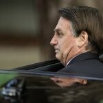 Brazil's President Jair Bolsonaro gets in a car after attending the swearing-in of Supreme Court Judge Kassio Nunes Marques in Brasilia, Brazil, Thursday, Nov. 5, 2020. (AP Photo/Eraldo Peres)