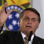 Brazil's President Jair Bolsonaro speaks during a ceremony presenting a program to restart tourism, amid the COVID-19 pandemic, at Planalto Palace in Brasilia, Brazil, Tuesday, Nov. 11, 2020. (AP Photo/Eraldo Peres)w