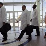 FILE - In this Aug. 26, 2013 file photo, Cuban doctors arrive for training before being assigned to work in impoverished areas where physicians and medical services are scarce, at the University of Brasilia in Brasilia, Brazil. A federal judge paved the way on Monday, Nov. 9, 2020, for a lawsuit against the Pan American Health Organization for its alleged role in the human trafficking of Cuban doctors to Brazil between 2013 and 2018 to be heard in the United States courts. (AP Photo/Eraldo Peres, File)