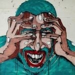 En la imagen, un graffiti que representa el dolor de cabeza.