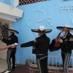 Mariachi band players wearing masks to curb the spread of the new coronavirus have their temperature taken before a Mother's Day performance at the Cristo Resucitado Church in Panama City, Tuesday, Dec. 8, 2020. Panamanian health authorities announced the extension of the night curfew hours in Panama City to face a rebound in coronavirus cases. (AP Photo/Arnulfo Franco)