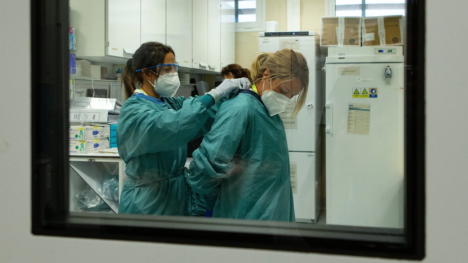 Dos profesionales sanitarios se preparan para manipular y tomar todos los datos referente al ensayo de la vacuna de Janssen, la cual se ha empezado a administrar desde hoy en fase III a participantes voluntarios de la vacuna contra la COVID-19, en el marco del ensayo clínico Ensemble 2, primero en esta fase nueva que se hace estado español. EFE/Enric Fontcuberta