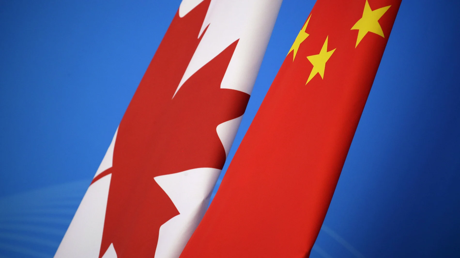 In this Nov. 12, 2018, file photo, flags of Canada and China are placed for the first China-Canada economic and financial strategy dialogue in Beijing, China. China says it has lodged a formal complaint with Canada over T-shirts ordered by one of the country’s Beijing Embassy staff that allegedly mocked China’s response to the coronavirus outbreak. (Jason Lee/Pool Photo via AP, File)