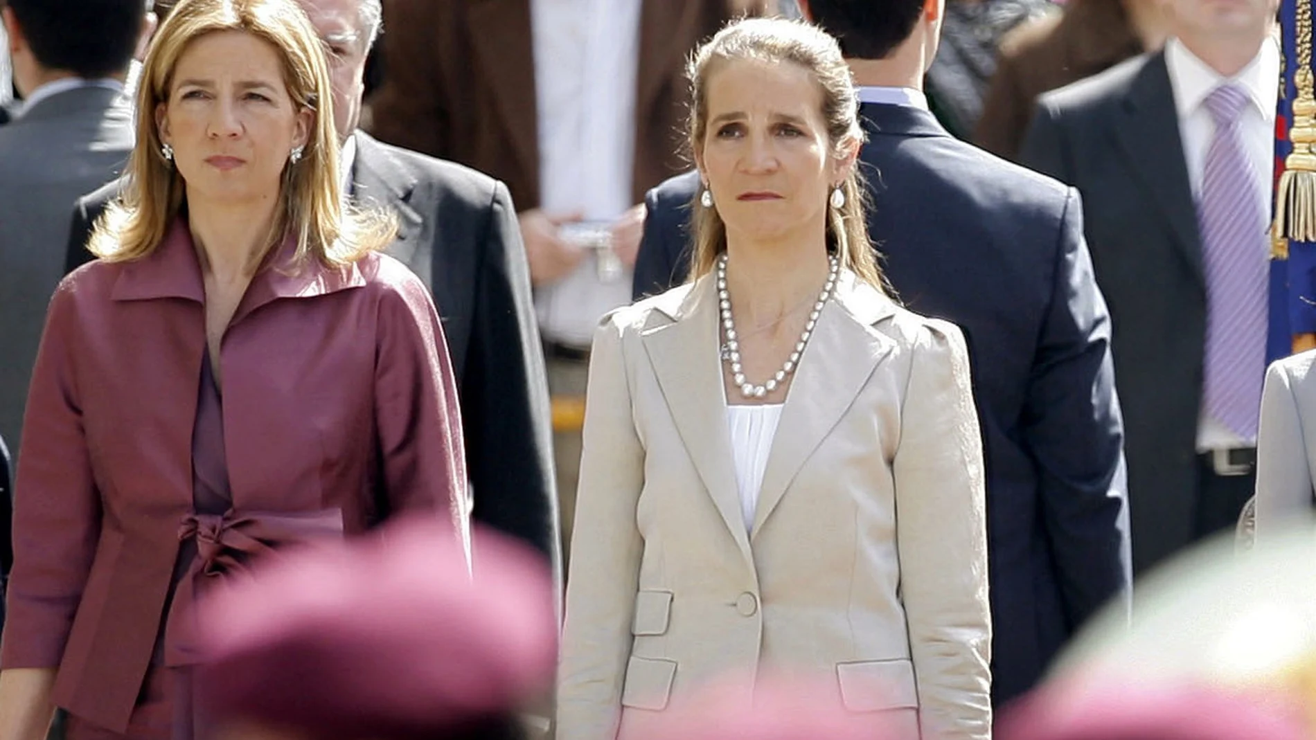 FILE - In this Wednesdday, April 16, 2008 file photo, Spain's Princess Cristina, left and Princess Elena, listen to the Spanish national anthem during a ceremony, upon their arrival for the opening of the Spanish Parliament, after Jose Luis Rodriguez Zapatero's Socialist Party won the general elections on March 9, in Madrid. The sisters of Spanish King Felipe VI have acknowledged on Wednesday, March 3, 2021, that they were administered COVID-19 vaccines during a visit to the United Arab Emirates. In a statement published by a Spanish newspaper, the Infantas Elena and Cristina said that they were “offered the possibility†of receiving vaccines while in Abu Dhabi to visit their father and former monarch, Juan Carlos I. (AP Photo/Daniel Ochoa de Olza, File)