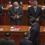 Former Hong Kong Chief Executive Tung Chee-hwa, second left top, claps to Chinese President Xi Jinping leaving after the closing session of the National People's Congress (NPC), at the Great Hall of the People, in Beijing, Thursday, March 11, 2021. Chinaâ€™s ceremonial legislature has endorsed the ruling Communist Partyâ€™s latest move to tighten control over Hong Kong by reducing the role of its public in picking the territoryâ€™s leaders. (Roman Pilipey/Pool Photo via AP)