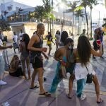 Un grupo de turistas baila en Ocean Drive durante las vacaciones de primavera en Miami Beach, Florida, el lunes 22 de marzo