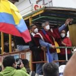 Former banker Guillermo Lasso, presidential candidate for the CREO political party, and his wife Maria de Lourdes Alcivar greet supporters from a "Chiva," an old truck converted to carry tourists, during a rally ahead of Ecuador's runoff presidential election in Quito, Ecuador, Wednesday, April 7, 2021. (AP Photo/Dolores Ochoa)