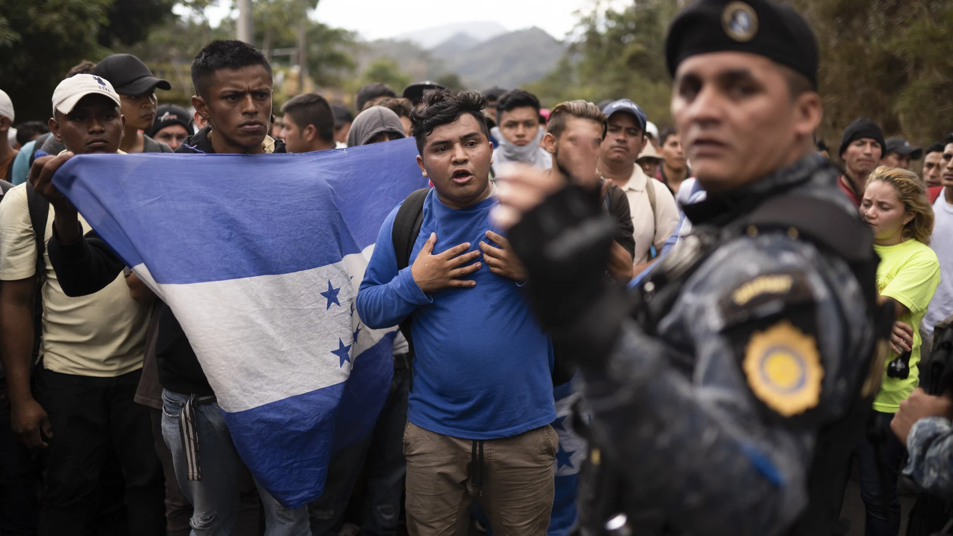 FILE - In this Jan. 16, 2020 file photo, Honduran migrants hoping to reach the U.S. border are stopped by Guatemalan police near Agua Caliente, Guatemala, on the border with Honduras. The reasons Hondurans continue to flee their country have been well documented: pervasive violence, deep-seated corruption, lack of jobs and widespread destruction from two major hurricanes that struck the region last November. (AP Photo/Santiago Billy, File, File)