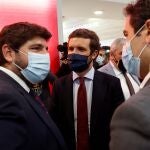 El presidente del Partido Popular (PP), Pablo Casado (c), visita la instalación de la Región de Murcia en Feria Internacional de Turismo FITUR acompañado por el presidente del PP y de la Región de Murcia, Fernando López Miras