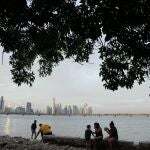 Tourists take photographs from the Casco Viejo neighborhood, at sunset in Panama City, Sunday, May 30, 2021. (AP Photo/Arnulfo Franco)
