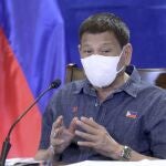In this photo provided by the Malacanang Presidential Photographers Division, Philippine President Rodrigo Duterte gestures as he meets members of the Inter-Agency Task Force on the Emerging Infectious Diseases at the Malacanang presidential palace in Manila, Philippines, Monday, June 21, 2021. The Philippine president has threatened to order the arrest of Filipinos who refuse COVID-19 vaccination and told them to leave the country for hard-hit countries like India and the United States if they would not cooperate with massive efforts to end the pandemic. (Simeon Celi/Malacanang Presidential Photographers Division via AP)