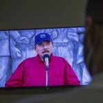 A man watches a televised national address by Nicaraguan President Daniel Ortega, at his home in Managua, Nicaragua, Wednesday, June 23, 2021. The president of the Inter-American Commission on Human Rights Antonia Urrejola says that Nicaragua has entered a new phase of repression with at least 20 opposition figures arrested in recent weeks and "constant human rights violations." (AP Photo/Miguel Andres)