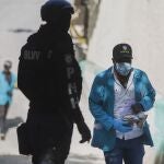 A forensic investigator carries a bagful of bullet casings collected at the residence of Haiti's President Jovenel Moise, near the leaderâ€™s residence where he was killed by gunmen in the early morning hours, in Port-au-Prince, Haiti, Wednesday, July 7, 2021. (AP Photo/Joseph Odelyn)