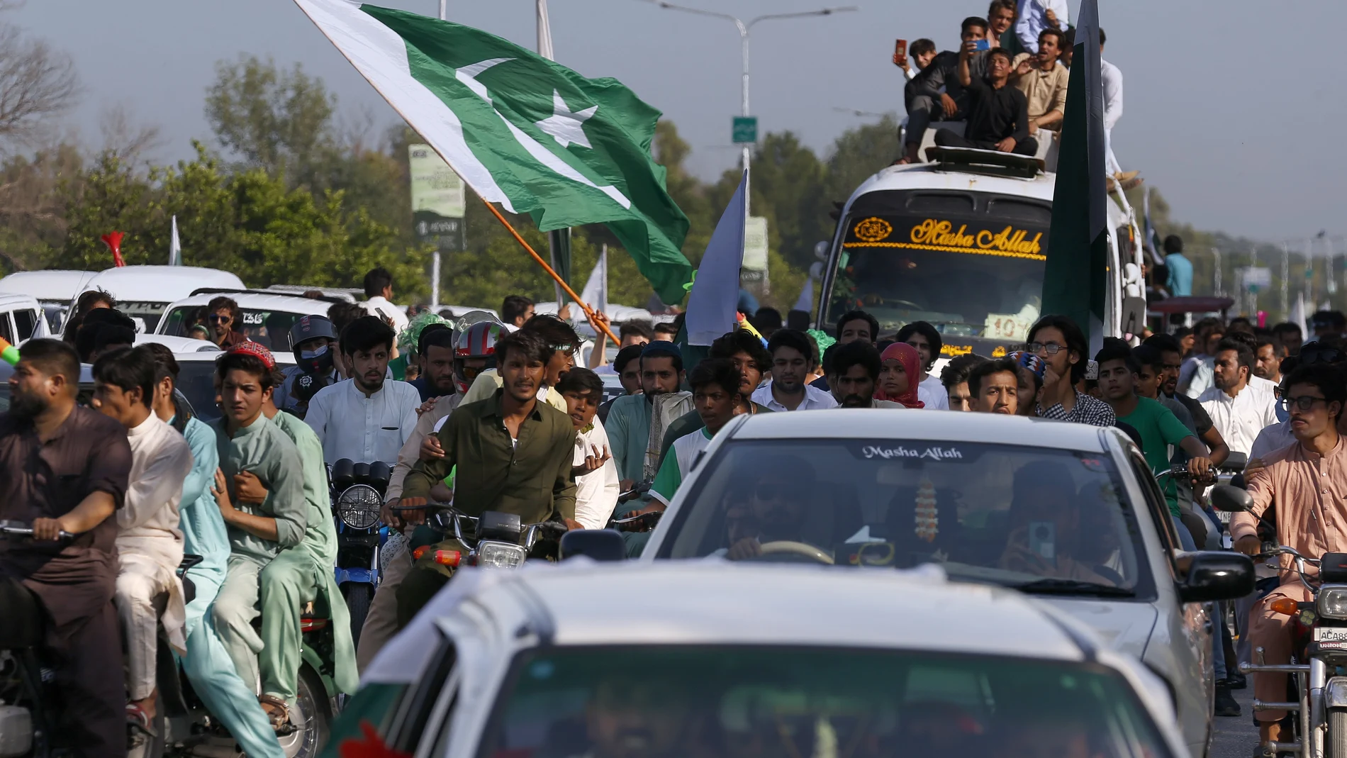Paquistaníes enarbolan banderas nacionales en la celebración del día de la independencia de Pakistán