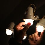 Una persona cambia una bombilla