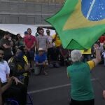 Supporters of Brazil's President Jair Bolsonaro pray in front of the Planalto presidential palace, ahead of Independence Day celebrations in Brasilia, Brazil, Monday, Sept. 6, 2021. (AP Photo/Eraldo Peres)