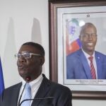 Haiti's newly-named Justice Minister Liszt Quitel, speaks during his installation ceremony, backdropped by a photo of assassinated President Jovenel Moise, in Port-au-Prince, Haiti, Thursday, Sept. 16, 2021. (AP Photo/Richard Pierrin)