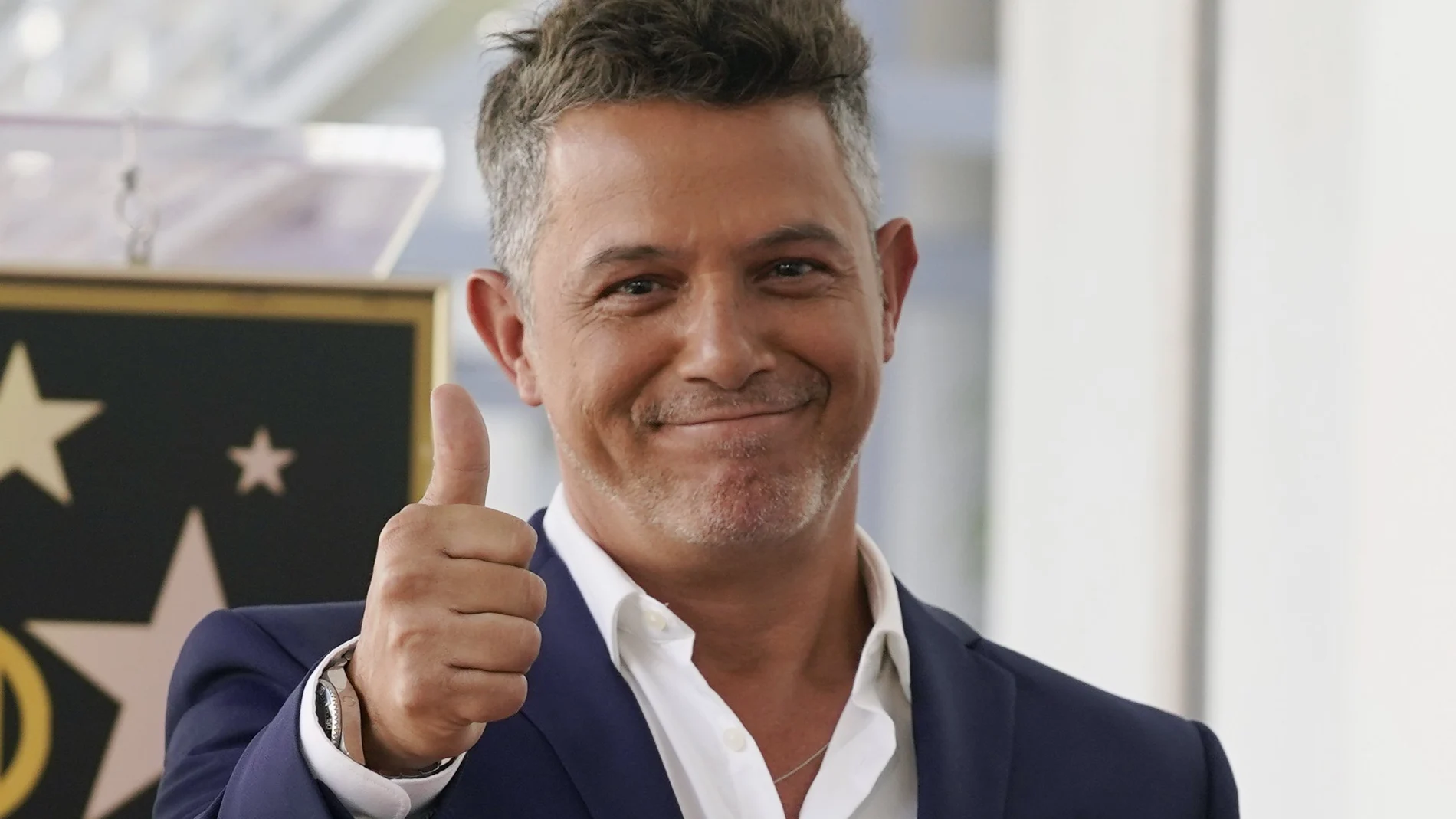 Spanish musician Alejandro Sanz holds a replica of his new star on the Hollywood Walk of Fame following a ceremony, Friday, Oct. 1, 2021, in Los Angeles. (AP Photo/Chris Pizzello)