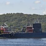 The Thames Towboat Co. tagboard John P. Wronowski and and Paul A. Wronowski ease the USS Nautilus to dock at Pier 2 at the U.S. Navy Submarine Base to start preservation work Friday, Oct. 15, 2021 in Groton, Conn. The Nautilus was the word's first nuclear powered submarine and made the first successful transit under the Arctic ice in 1958. The $36 million preservation project to ensure the National Historic Landmark and Connecticut's State Ship will remain the centerpiece of the museum. (Sean D. Elliot/The Day via AP)