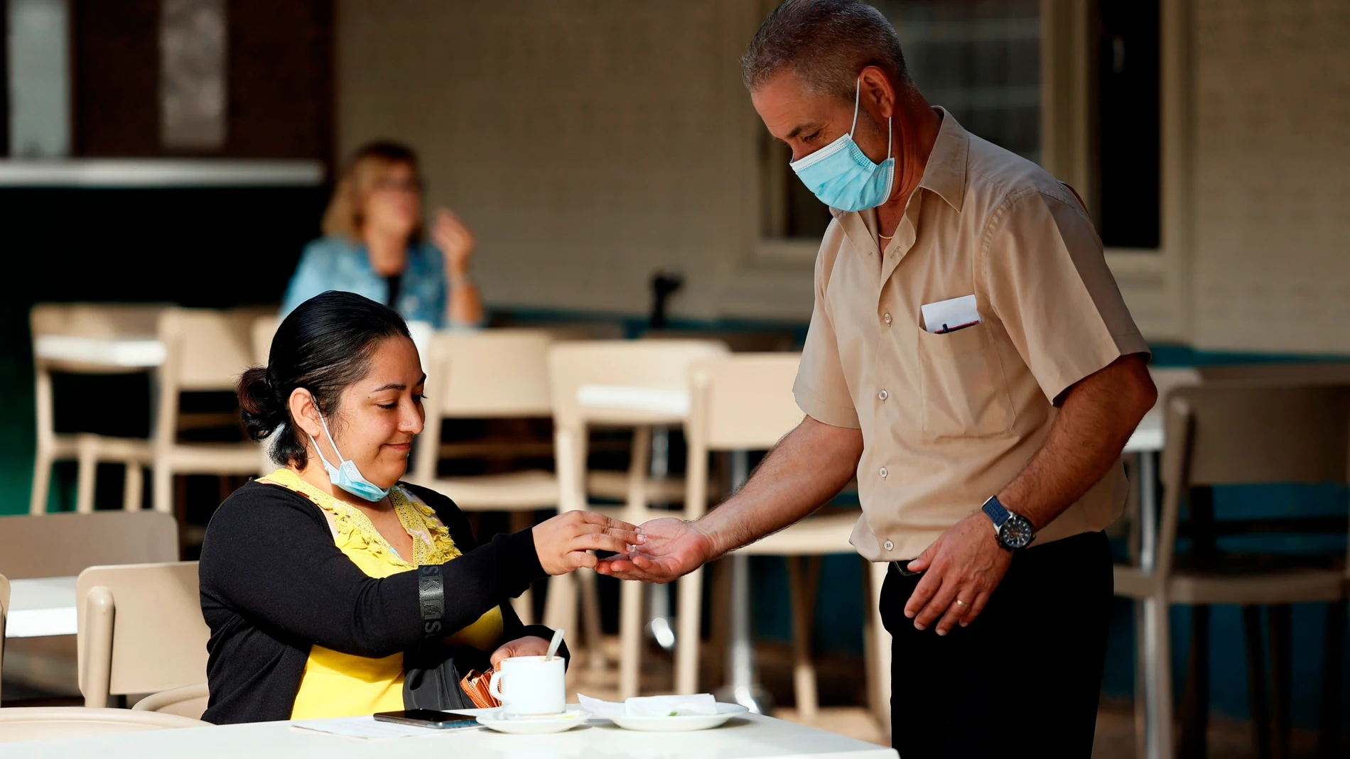 Un camarero sirve una mesa en un restaurante de Valencia