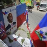 FILE - In this July 21, 2021 file photo, a mural depicting the late President Jovenel Moise adorns a wall in the Kenscoff neighborhood of Port-au-Prince, Haiti. A police superintendent in Jamaica told The Associated Press on Thursday, Oct. 21, 2021, that authorities have arrested a Colombian man they believe is a suspect in the July 7 assassination of Moise. (AP Photo/Joseph Odelyn)
