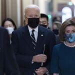 El presidente Joe Biden camina junto a la presidenta de la Cámara de Representantes, Nancy Pelosi, en el Capitolio