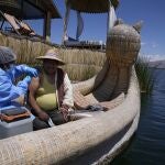 A healthcare worker injects Julio Vilca with a dose of the Pfizer COVID-19 vaccine during a door-to-door vaccination campaign aimed at Lake Titicaca residents in Puno, Peru, Wednesday, Oct. 27, 2021. (AP Photo/Martin Mejia)