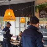 November 24, 2021, Draguignan, Var, France: Police officers are seen checking the health pass of a customer in a restaurant..Due to a surge in Covid-19 positive cases, the French government has decided to reinforce the controls on the obligation of the Sanitary Pass in restaurants and bars. The main objective for the French government is to slow down a fifth wave of contamination before the Christmas period and to avoid confinement measures.24/11/2021