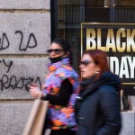Imagen de tiendas en Black Friday. Pintada de "No a la Ley Mordaza".