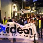 Un grupo de personas participa con pancartas y banderas en un homenaje a los etarras Henri Parot, Pagoaga Gallastegui, y Eugenio Barrutiabengoa, en Mondragón