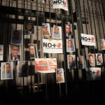 Periodistas pegan fotografías de compañeros asesinados como protesta, en una valla en la Secretaria de Gobernación (SG), el 14 de febrero de 2022.