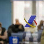 Varias personas esperan en una oficina de la Agencia Tributaria un día antes de que dé comienzo la Campaña de la Renta 2021