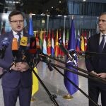 Ukraine's Foreign Minister Dmytro Kuleba, left, and NATO Secretary General Jens Stoltenberg speak with the media as they arrive for a meeting of NATO foreign ministers at NATO headquarters in Brussels, Thursday, April 7, 2022. NATO foreign ministers are meeting to discuss how to bolster their support to Ukraine, including by supplying weapons to the conflict-torn country, without being drawn into a wider war with Russia. (AP Photo/Olivier Matthys)