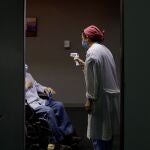 Una sanitaria atiende a un paciente en el Hospital Provincial de Castellón