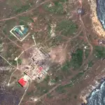 This satellite image provided by Maxar Technologies shows destroyed buildings, probable Pantsir air defense vehicles and a destroyed helicopter on Snake Island in the Black Sea Thursday, May 12, 2022. (Satellite image ©2022 Maxar Technologies via AP)