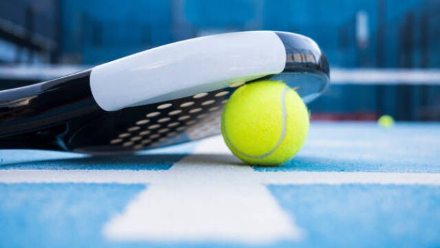 Paddle tennis court, net, racket, balls.