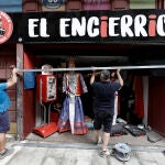 Dos trabajadores realizan pruebas para la colocación de un vallado en una tienda de la calle de Mercaderes por donde discurrirían los encierros de estos Sanfermines 2022. EFE/ Jesús Diges
