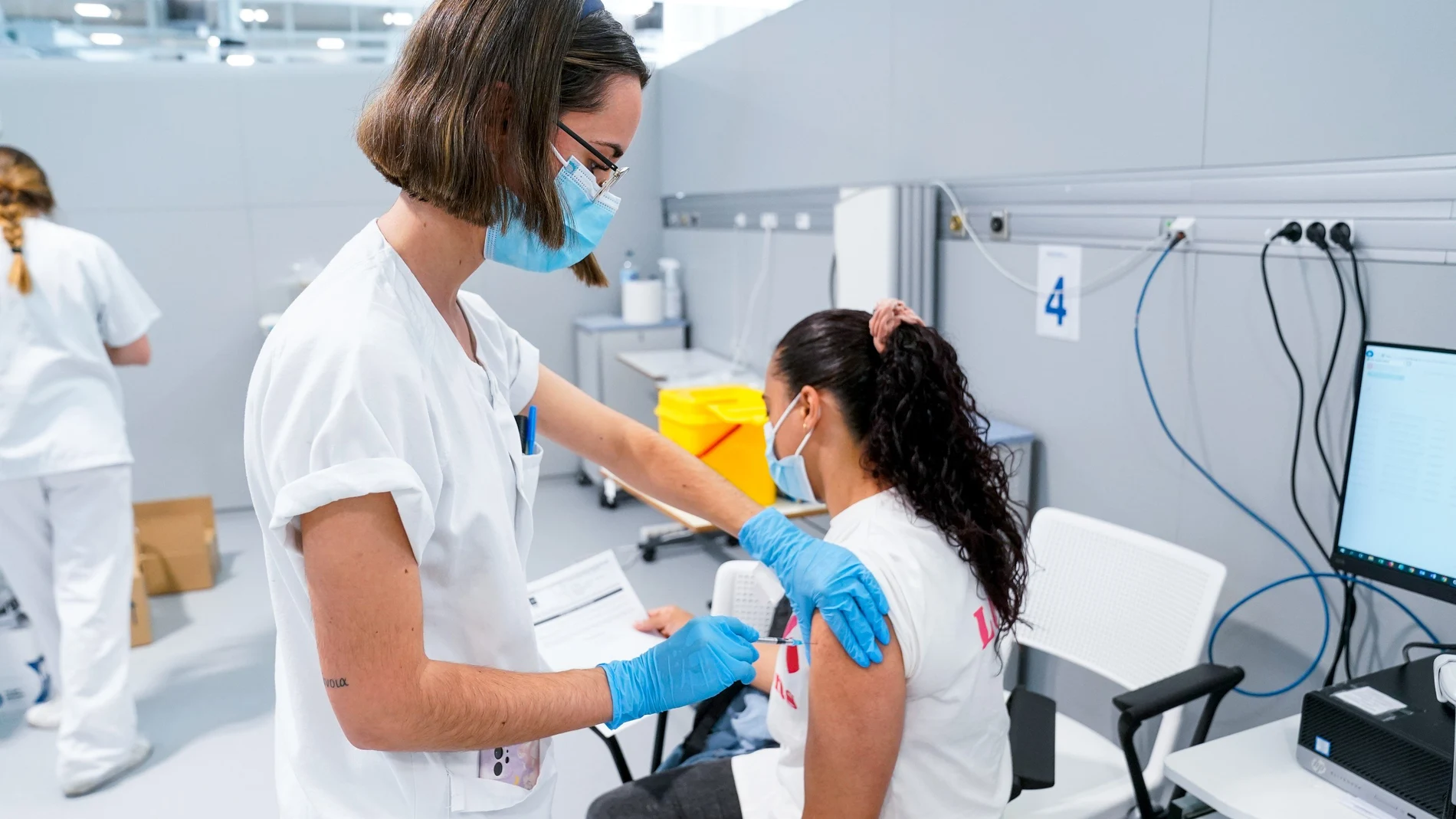 Una enfermera vacuna a una mujer en el Hospital público de emergencias Enfermera Isabel Zendal, a 28 de junio de 2021, en Madrid, (España). A partir de hoy este hospital va a comenzar a vacunar contra el Covid-19, 24 horas al día, a través del sistema de autocitación. En el recinto se pondrán en torno a 150.000 vacunas a la semana de manera ininterrumpida. 28 JUNIO 2021;MADRID;ZENDAL;VACUNA;COVID-19;PANDEMIA;AUTOCITACIÓN A. Pérez Meca / Europa Press 28/06/2021