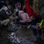 Los residentes enchufan teléfonos móviles y bancos de energía en un punto de carga en el centro de Jersón