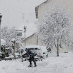 GRAFCAV4035. ESPINAL, 16/01/2023.- Una persona intenta limpiar de nieve para poder sacar su vehículo de una calle de la localidad de Espinal donde una intensa nevada caída durante la jornada de este lunes cubre completamente la carretera. EFE/ Jesus Diges