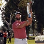 Jon Rahm hold the winner's trophy after winning the Genesis Invitational golf tournament at Riviera Country Club, Sunday, Feb. 19, 2023, in the Pacific Palisades area of Los Angeles