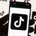 The TikTok logo is seen on a cell phone on Oct. 14, 2022, in Boston. The White House is giving all federal agencies 30 days to wipe TikTok off all government devices, as the Chinese-owned social media app comes under increasing scrutiny in Washington over security concerns. 