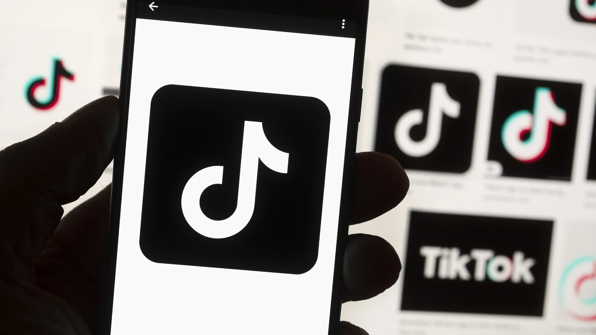 The TikTok logo is seen on a cell phone on Oct. 14, 2022, in Boston. The White House is giving all federal agencies 30 days to wipe TikTok off all government devices, as the Chinese-owned social media app comes under increasing scrutiny in Washington over security concerns.
