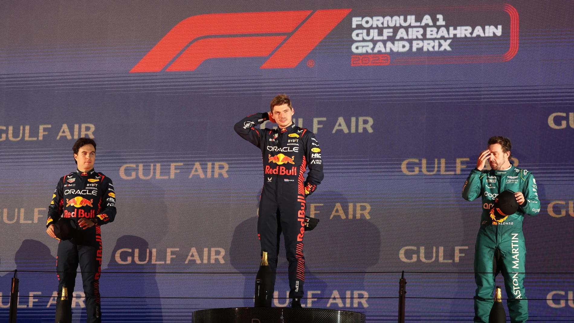 Sakhir (Bahrain), 05/03/2023.- Dutch Formula One driver Max Verstappen (C), Mexican Formula One driver Sergio Perez of Red Bull Racing (L) and Spanish Formula One driver Fernando Alonso of Aston Martin (R) pose on the podium after the Formula One Grand Prix of Bahrain at the Bahrain International Circuit in Sakhir, Bahrain, 05 March 2023. (Fórmula Uno, Bahrein) EFE/EPA/Ali Haider