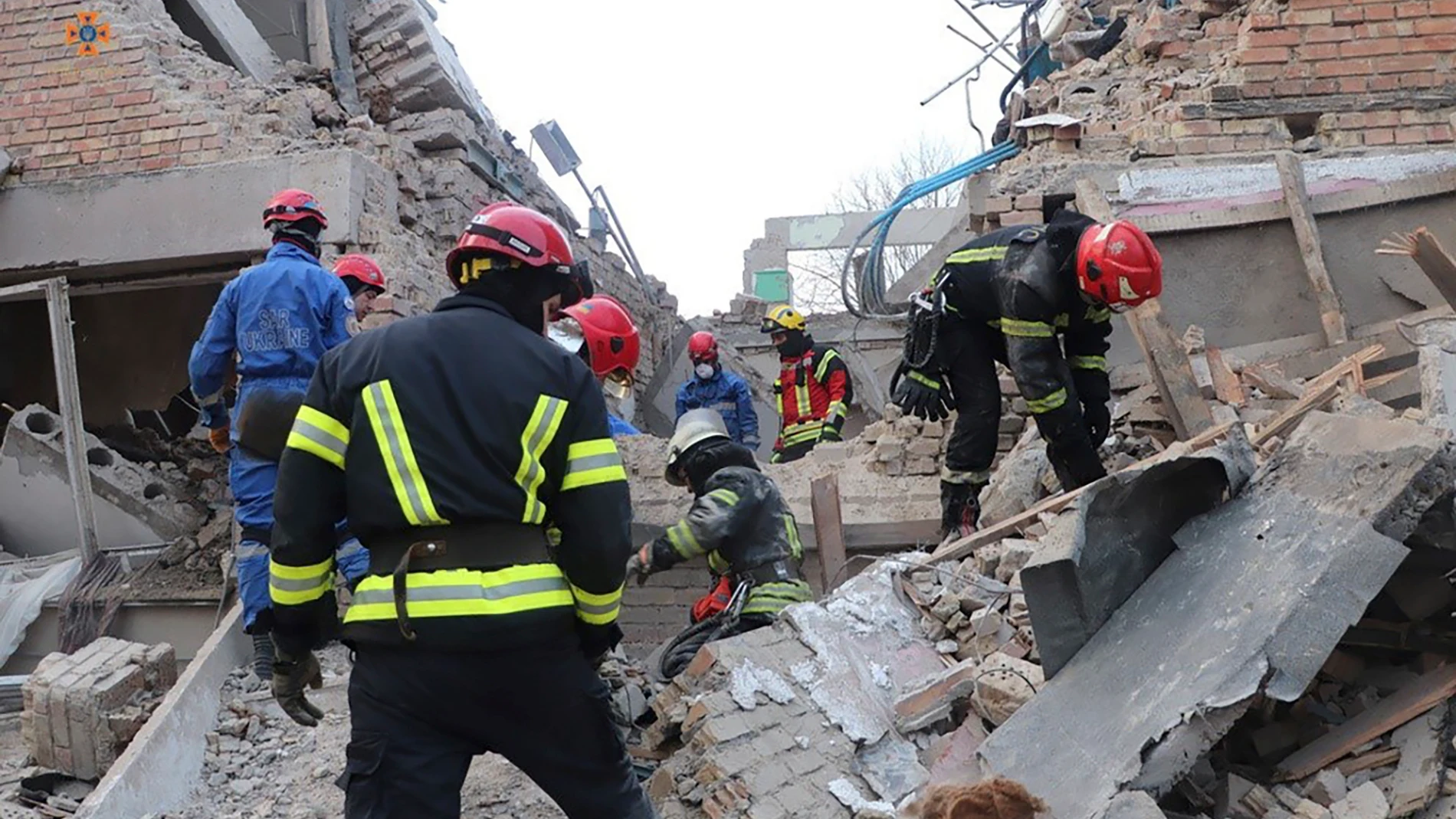 In this photo provided by the Ukrainian Emergency Service, emergency personnel work at the scene following a drone attack in the town of Rzhyshchiv, Kyiv region, Ukraine, Wednesday, March 22, 2023. (Ukrainian Emergency Service via AP Photo)