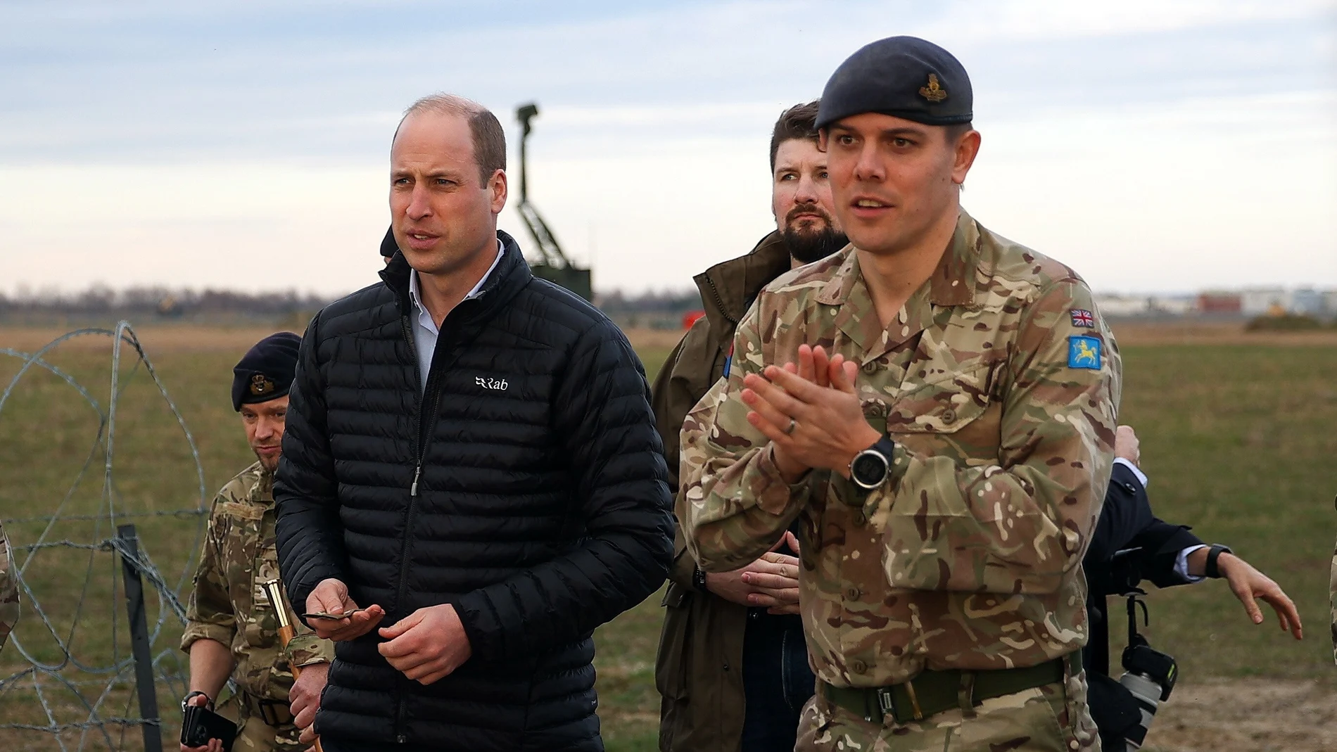 Britain's Prince William (L) meets with soldiers during a visit of the British military base in Jasionka, southeast Poland, 22 March 2023. The Prince of Wales arrived for a two-day visit to meet British and Polish troops based near the border with Ukraine.