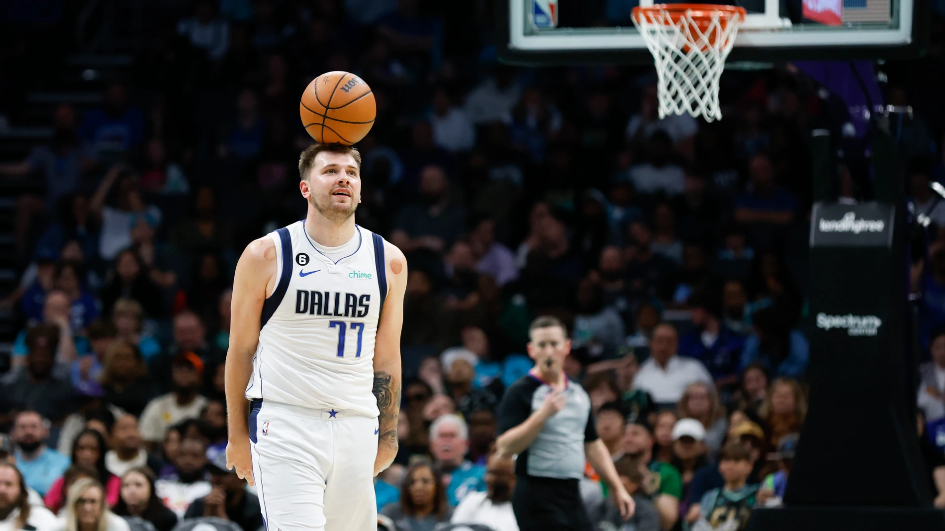 Dallas Mavericks guard Luka Doncic balances the basketball on his head after a foul was called on Dallas during the second half of an NBA basketball game against the Charlotte Hornets in Charlotte, N.C., Sunday, March 26, 2023. Charlotte won 110-104. (AP Photo/Nell Redmond)