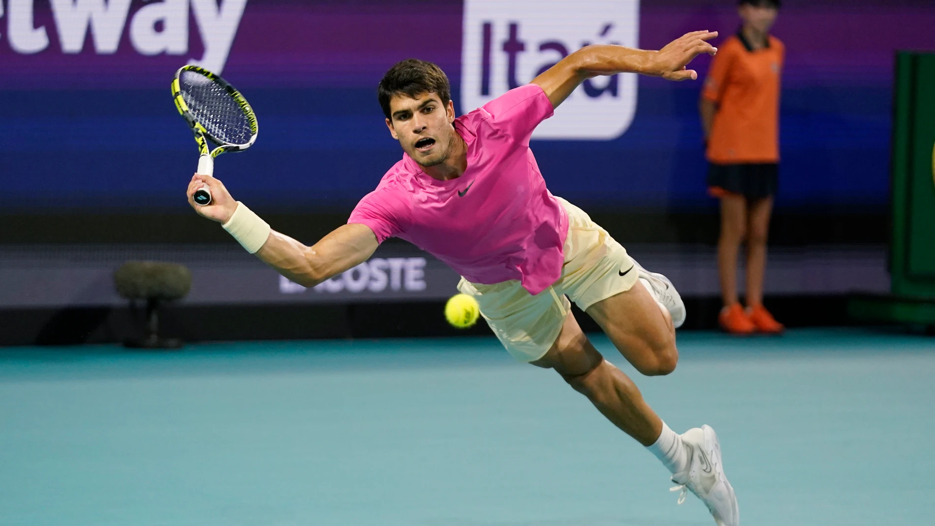Carlos Alcaraz, of Spain, dives as he attempts to return a shot by Jannik Sinner, of Italy, during the Miami Open tennis tournament, Friday, March 31, 2023, in Miami Gardens, Fla. (AP Photo/Wilfredo Lee)